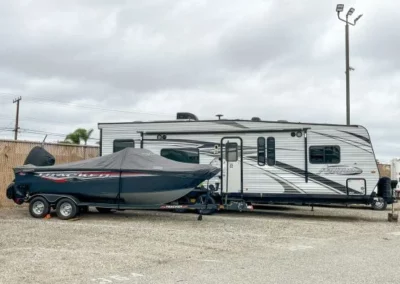 A parked trailer RV and boat